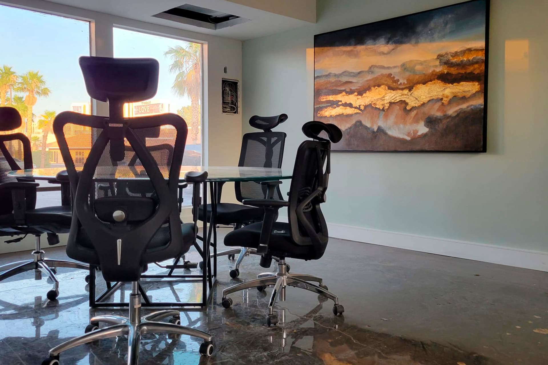 Conference Room I, with a glass table and view of the Strip