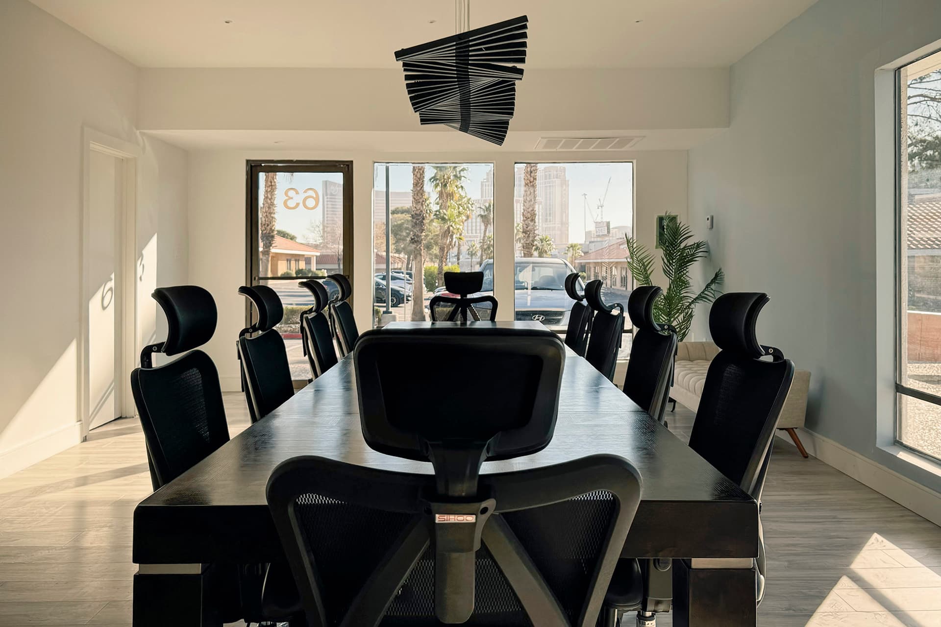 Conference Room III, seating twelve under a sculptural pendant